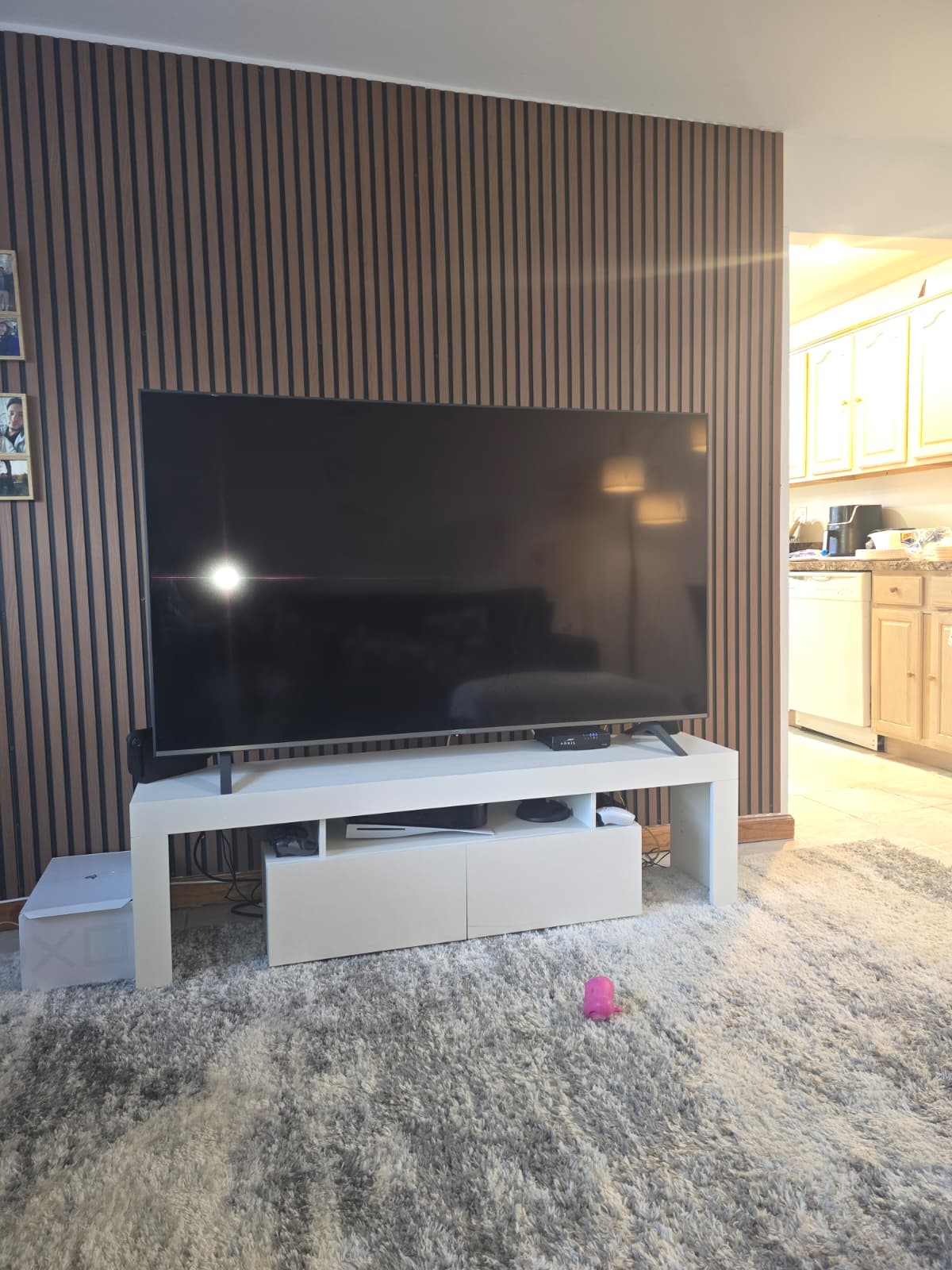 TV mounted on a wood slat accent wall installed in a New York living room