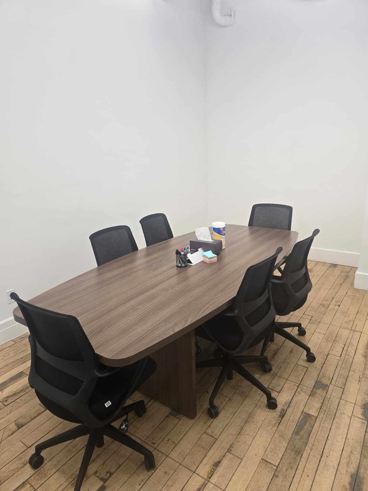Office conference room with table and chairs after build-out and final cleaning