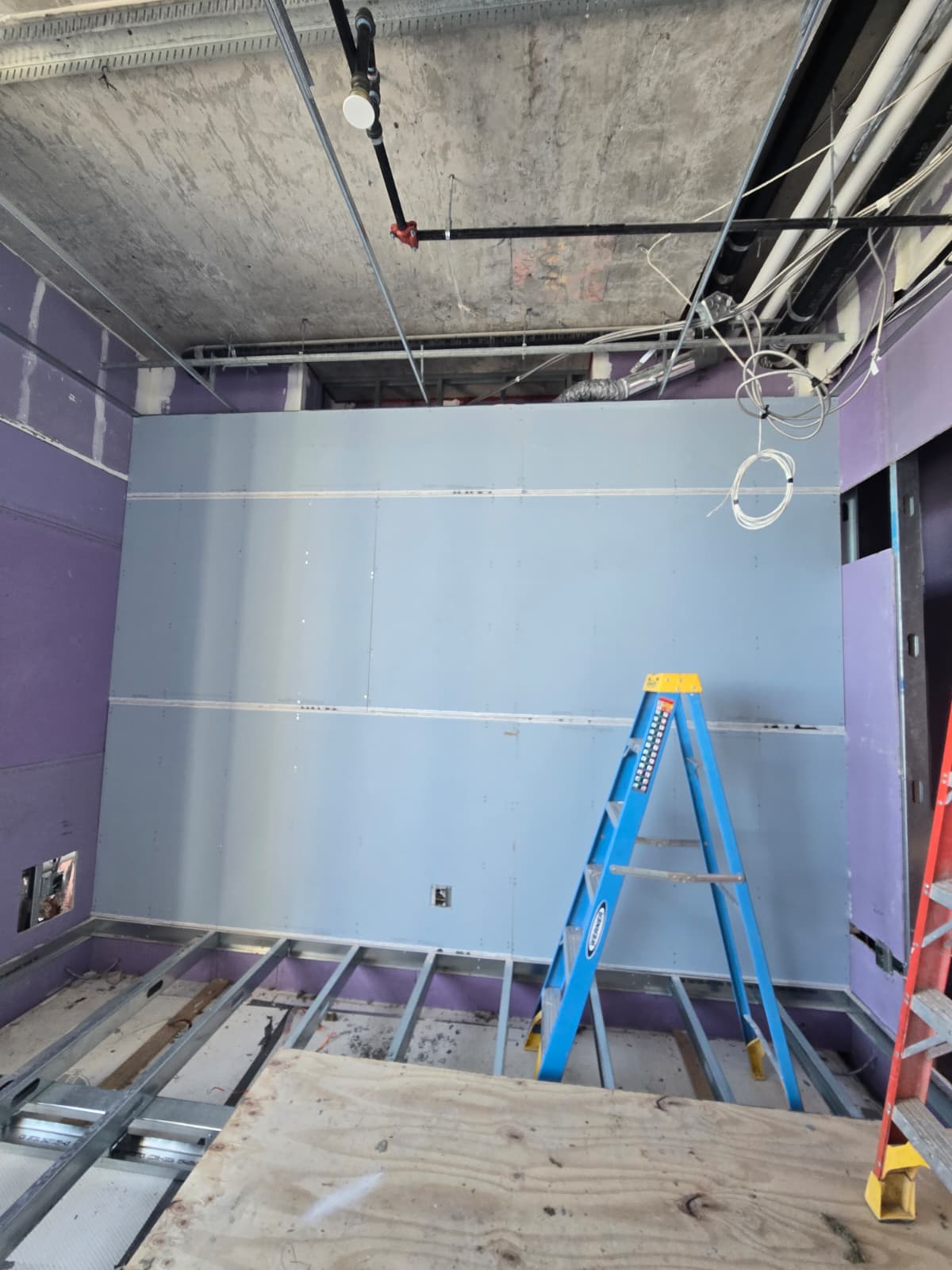 Metal framing and drywall wall installed in a New York apartment
